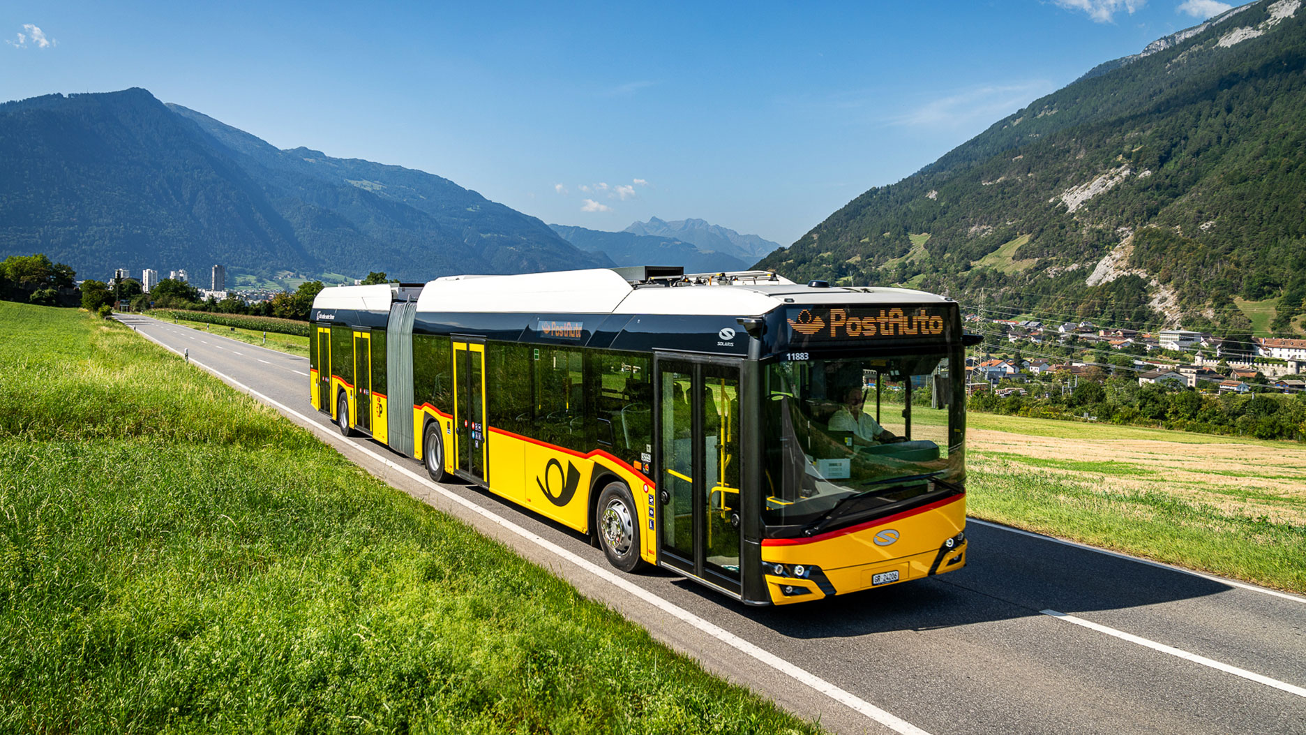 PostAuto bus on a rural Swiss road